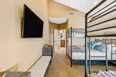 a bedroom with bunk beds and a flat screen tv at Rivo of Dreams in Long Beach
