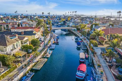 an aerial view of a city with boats in a canal at Rivo of Dreams in Long Beach