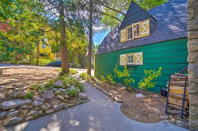 a green house with a blue roof at Vintage Lake Arrowhead Cabin - Walk to Lake! in Lake Arrowhead