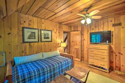 a living room with a couch and a ceiling fan at Vintage Lake Arrowhead Cabin - Walk to Lake! in Lake Arrowhead