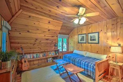 a bedroom with a bed and a ceiling fan at Vintage Lake Arrowhead Cabin - Walk to Lake! in Lake Arrowhead