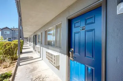 a blue door on the side of a building at ERTH INN by AGA- Mojave in Mojave