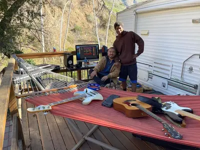 two men are standing in front of a table withweapons at Vintage RV Creekside Nature Retreat near Ojai next to Swim Holes Hike in Santa Paula