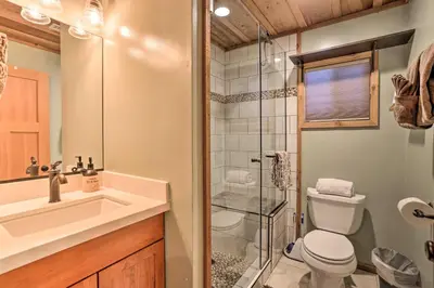 a bathroom with a shower and a toilet and a sink at Walk to Big Bear Lake Cozy Cabin with Deck in Big Bear Lake