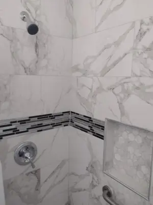 a bathroom with a shower with white marble walls at Sky Fresh Home Stay in Apple Valley