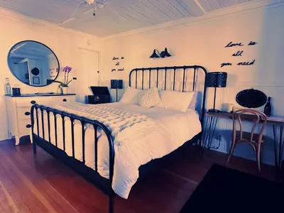 a bedroom with a bed with a mirror and a mirror at 100 Mile View-Fire Pit, Romantic, Peaceful, Private in Crestline