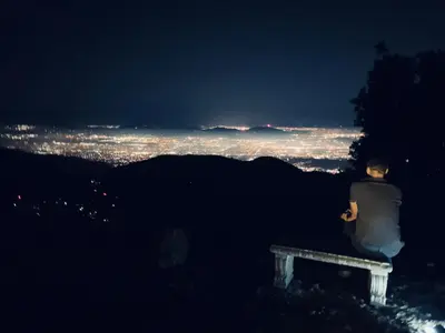 a person sitting on a bench at night at 100 Mile View-Fire Pit, Romantic, Peaceful, Private in Crestline