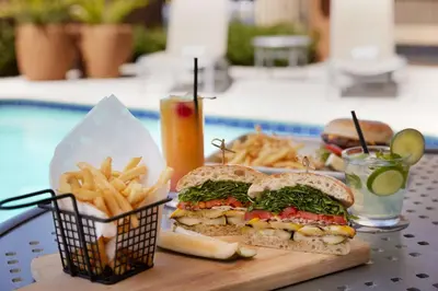 a sandwich and french fries and a drink on a table at Hilton Garden Inn Los Angeles/Redondo Beach in Redondo Beach