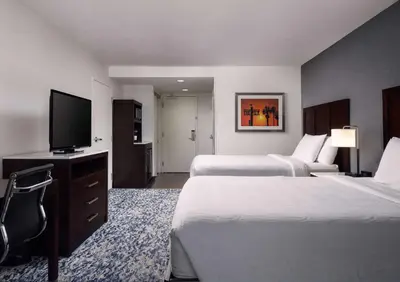 a hotel room with two beds and a flat screen tv at Hilton Garden Inn Los Angeles/Redondo Beach in Redondo Beach