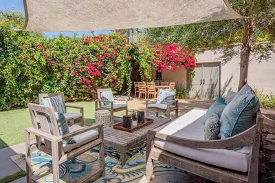 a patio with chairs and a couch and a table at Secluded 4BR Spanish Oasis in the Heart of LA in Los Angeles