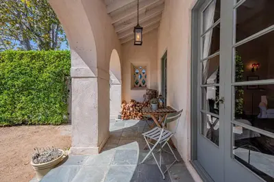 a patio with a glass door and a table with someitures at Secluded 4BR Spanish Oasis in the Heart of LA in Los Angeles