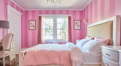 a pink bedroom with a large bed and a desk at Hollywood Home in Los Angeles