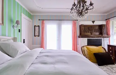 a bedroom with a large white bed and a chandelier at Hollywood Home in Los Angeles