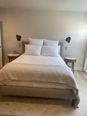 a bedroom with a large bed with two tables at The Best Santa Monica Beach Area, Any days,Newly Remodeled in Los Angeles