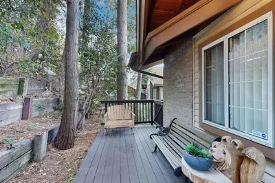 a porch of a house with a bench and plants at Lakeside Serenity in Crestline
