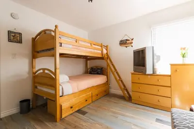 a bedroom with two bunk beds and a tv at Charming LA 2 Bedroom For Your Home Away From Home in Los Angeles