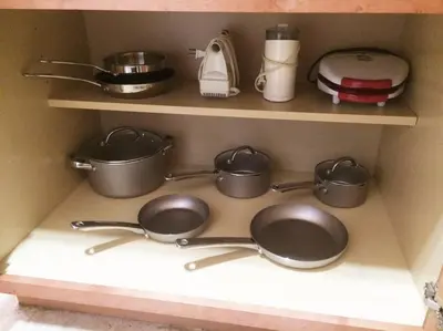 a kitchen shelf with pots and pans and a toaster at Charming LA 2 Bedroom For Your Home Away From Home in Los Angeles