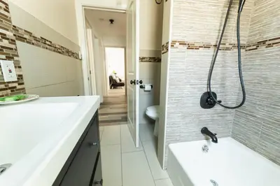a bathroom with a sink and a shower and a toilet at Charming LA 2 Bedroom For Your Home Away From Home in Los Angeles