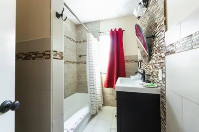 a bathroom with a tub and a sink and a shower at Charming LA 2 Bedroom For Your Home Away From Home in Los Angeles