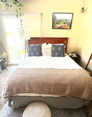 a bedroom with a large bed and a window at Sweet Tuscan Dreams-Private Entrance & Bathroom with Patio in Encino