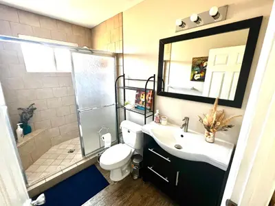 a bathroom with a toilet and a sink and a shower at Sweet Tuscan Dreams-Private Entrance & Bathroom with Patio in Encino