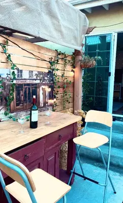 a bar with two chairs and a bottle of wine at Sweet Tuscan Dreams-Private Entrance & Bathroom with Patio in Encino