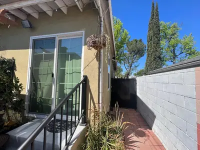 a house with a porch and a fence at Sweet Tuscan Dreams-Private Entrance & Bathroom with Patio in Encino