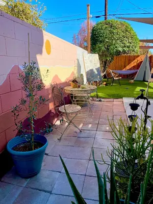 a patio with a table and chairs next to a wall at Sweet Tuscan Dreams-Private Entrance & Bathroom with Patio in Encino