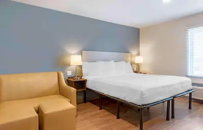 a bedroom with a bed and a couch and a chair at Extended Stay America Suites - Norco in Norco