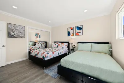 a bedroom with two beds and a window at Sunny & Cheerful Near I-10 Queen Beds w Parking! in Alhambra