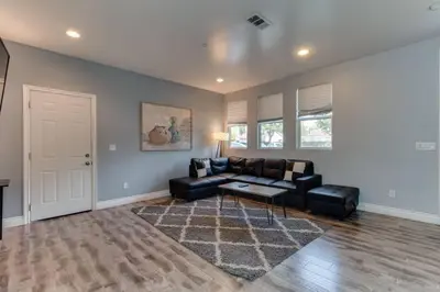 a living room with a couch and a table at Stylish Modern Lake Balboa Retreat 3 Bedroom House in Van Nuys