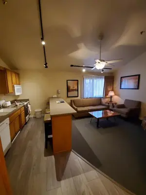 a kitchen and living room with a couch and a table at GetAways at Snow Lake Lodge in Big Bear Lake