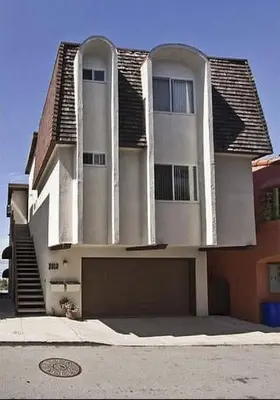 a large white house with a garage in front of it at Beautiful Views - Sand Section of Manhattan Beach 2 Bed/2 Bath in Manhattan Beach
