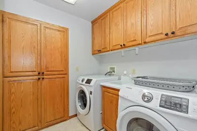 a laundry room with a washing machine and a washer at CUSTOM SINGLE STORY CABIN WITH JACUZZI POOL TABLE & BIG GAME ROOM WITH ARCADE games in Big Bear Lake