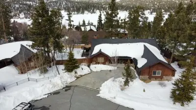 an aerial view of a house covered in snow at CUSTOM SINGLE STORY CABIN WITH JACUZZI POOL TABLE & BIG GAME ROOM WITH ARCADE games in Big Bear Lake