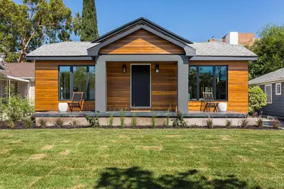 a house with a deck with two chairs on it at Modern Bungalow with a Pool in Larchmont Village in Los Angeles