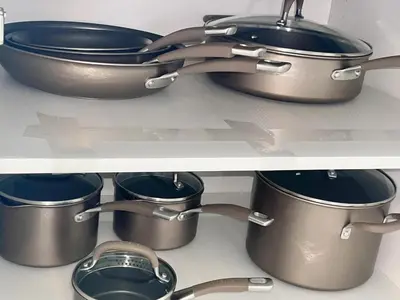 two pots and pans on a shelf in a kitchen at Huge Family Home Near Disneyland & SoCal Beaches in Midway City