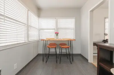 a small kitchen with a table and two stools at Cool and Cozy Pad Close to Everything in Los Angeles