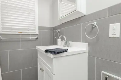 a white bathroom with a sink and a mirror at Cool and Cozy Pad Close to Everything in Los Angeles