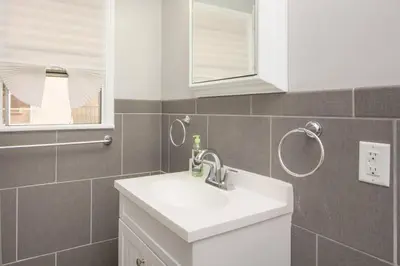 a bathroom with a white sink and a window at Cool and Cozy Pad Close to Everything in Los Angeles
