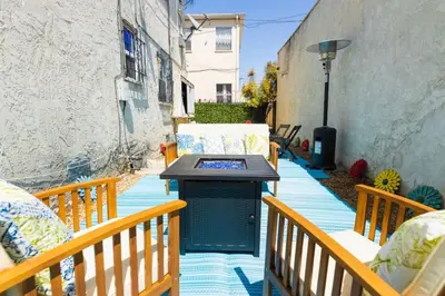 a patio with a table and chairs on a balcony at Spring Charmer In The Heart Of The City in Los Angeles