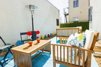 a patio with two chairs and a table at Spring Charmer In The Heart Of The City in Los Angeles