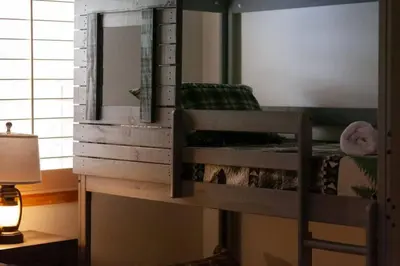 a bedroom with a bunk bed with a mirror at Hillside Hideaway - game rm - master spa - Luxury in Lake Arrowhead