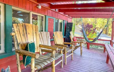 two rocking chairs sitting on a porch of a house at ITH Big Bear Lake Hostel & Lodge in Big Bear Lake