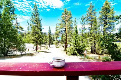 a cup of coffee sitting on top of a red table at ITH Big Bear Lake Hostel & Lodge in Big Bear Lake