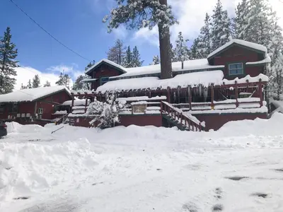 a house covered in snow in front of it at ITH Big Bear Lake Hostel & Lodge in Big Bear Lake