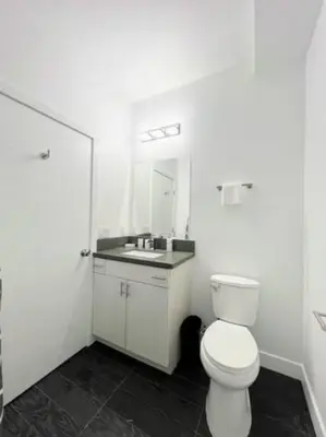 a bathroom with a white toilet and a sink at 4BR Townhouse in KoreaTown in Los Angeles