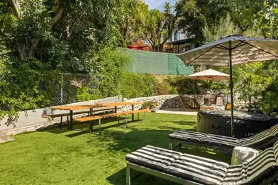a garden with benches and tables and an umbrella at Echo Park Hills - Walk to Dodger Stadium - Near DTLA SoFi in Los Angeles