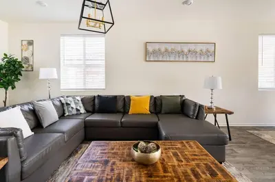 a living room with a couch and a table at Spacious Modern Home in Sierra Lakes Fontana in Fontana