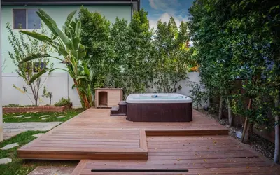 a hot tub sitting on top of a wooden deck at LA Dream Gem - Beautiful Home with Spa in Los Angeles
